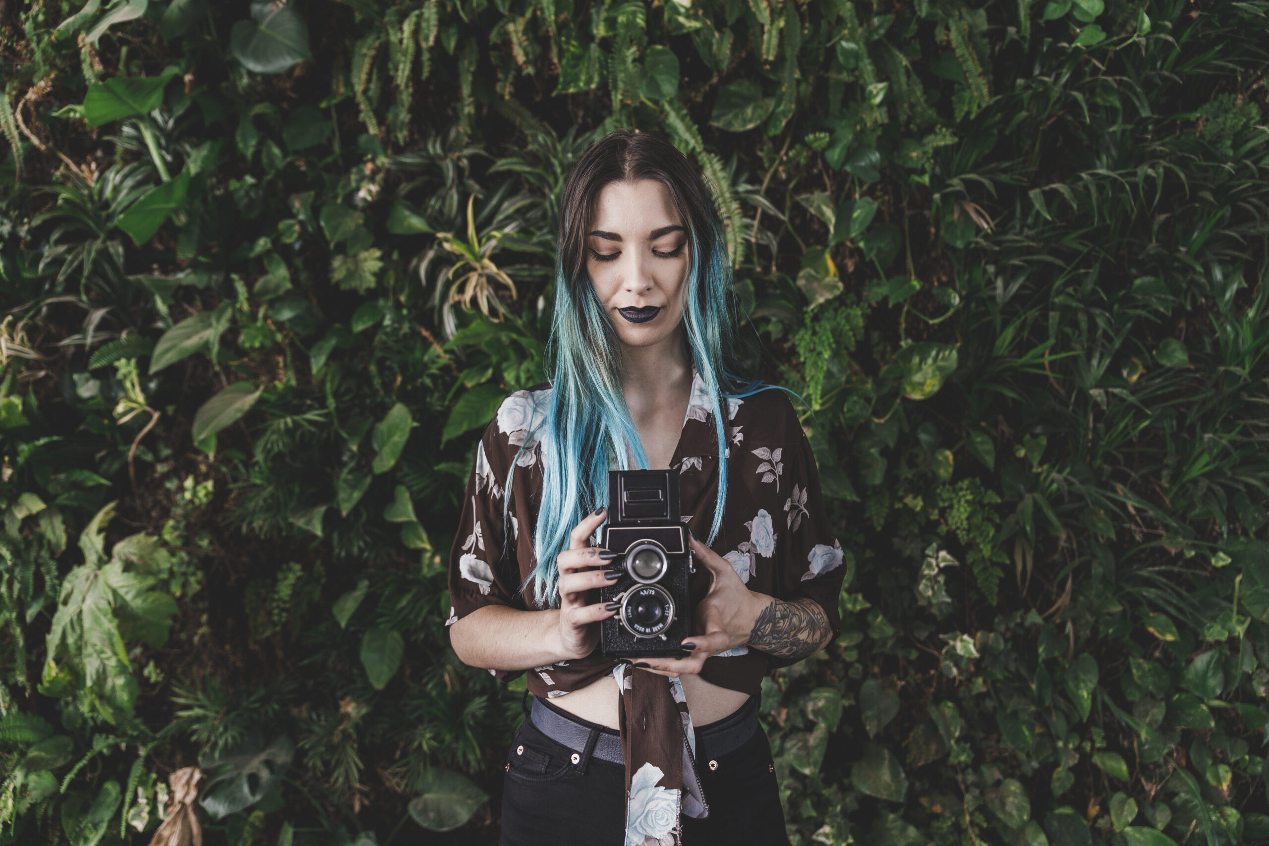 smiling-young-woman-photographing-with-vintage-camera